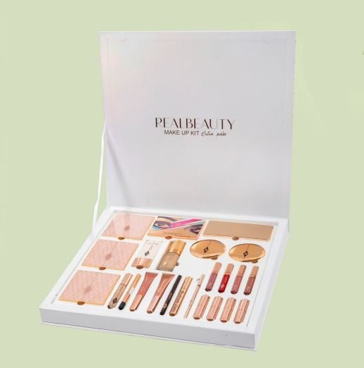 Pearl Beauty makeup kit box with assorted cosmetics on a light green background