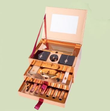 Luxury rose gold beauty box with compartments of makeup products and built-in mirror